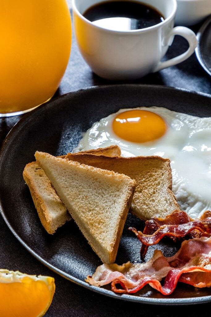 Breakfast plate with eggs, bacon, and sandwiches at Bikini Bottom Express in Da Nang