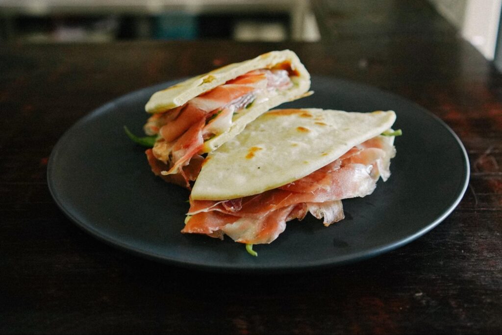 Traditional Piadina from Emilia-Romagna filled with prosciutto, arugula and cheese